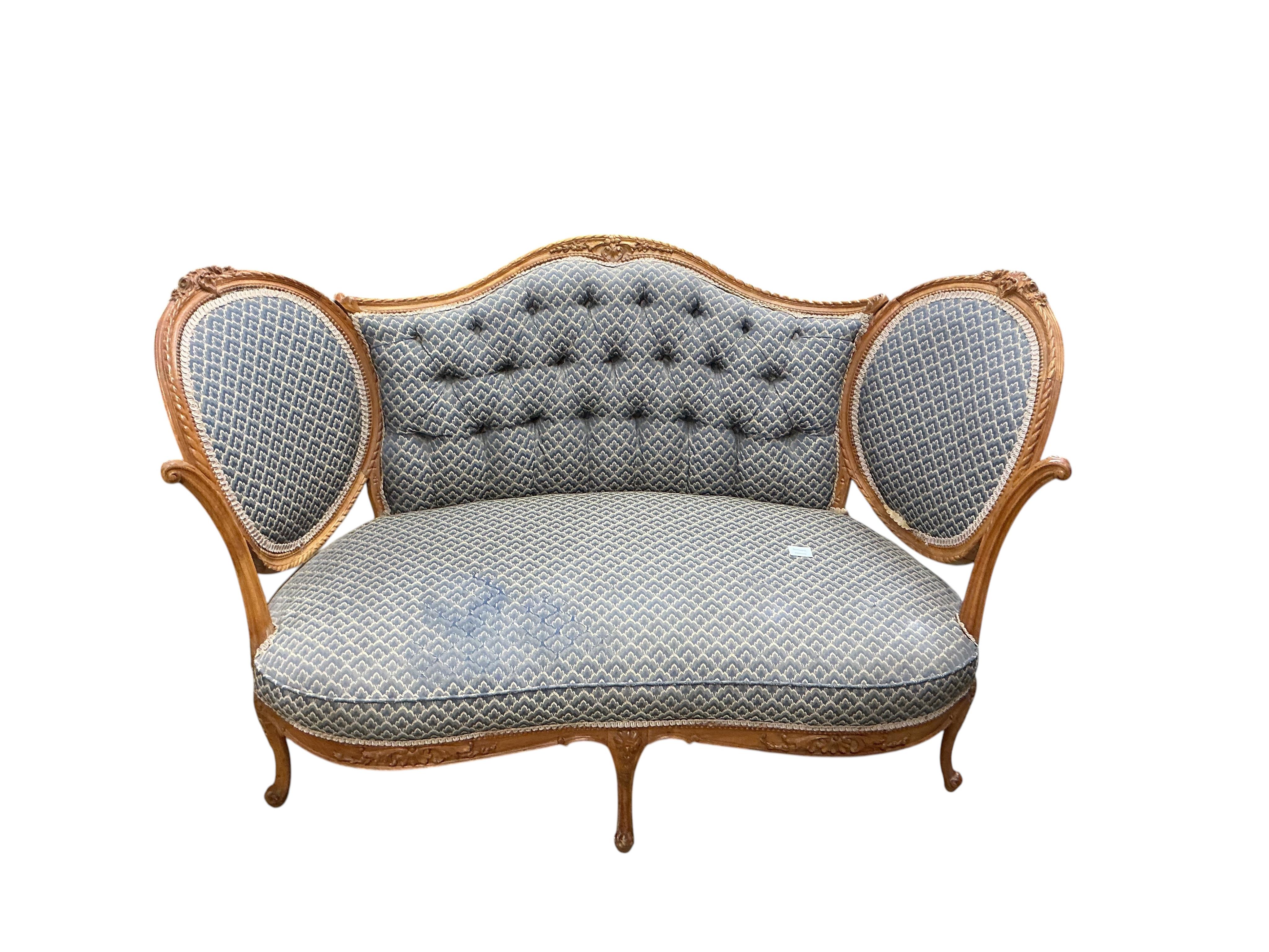 A late 19th / early 20th century French upholstered carved walnut upholstered settee, width 136cm, depth 68cm, height 86cm